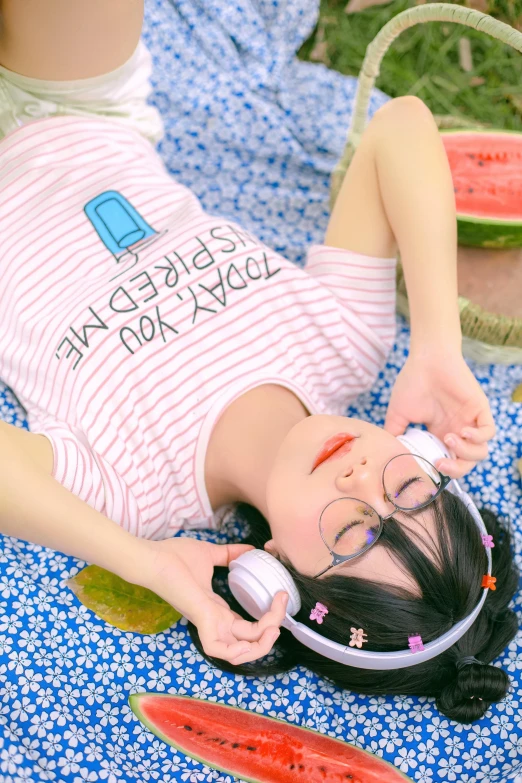a girl is laying down on the ground with her head up and hairdryers attached to her ears