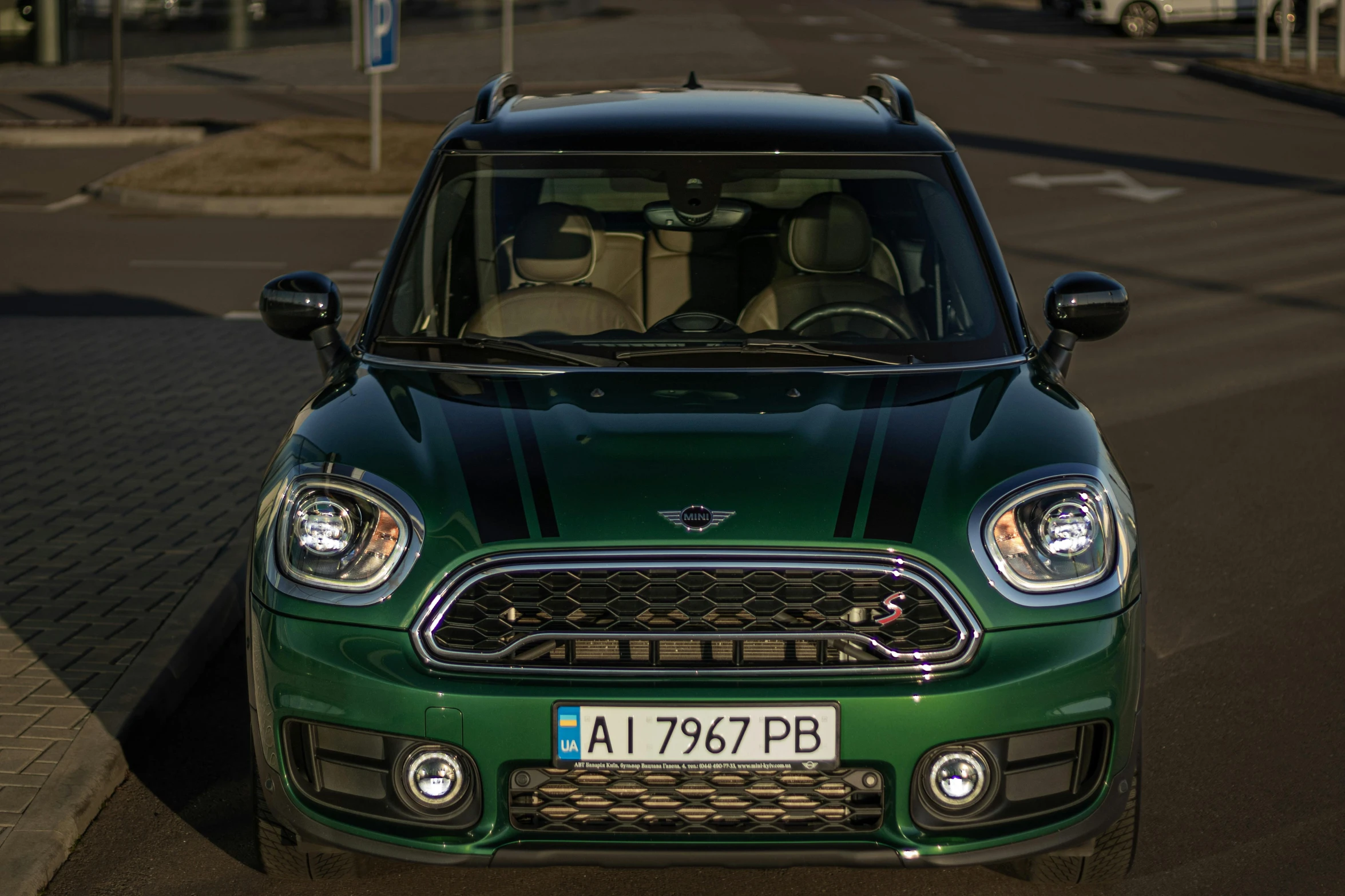 the front view of a green and black minivan