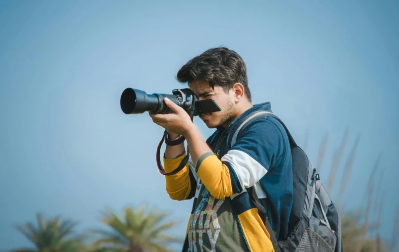 the man is taking a picture with his camera