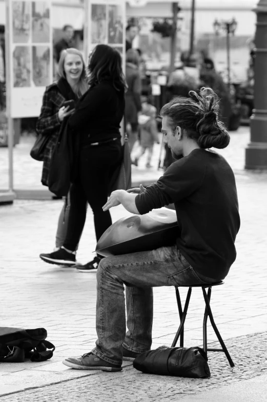 a man sitting on a bench in the middle of a walkway