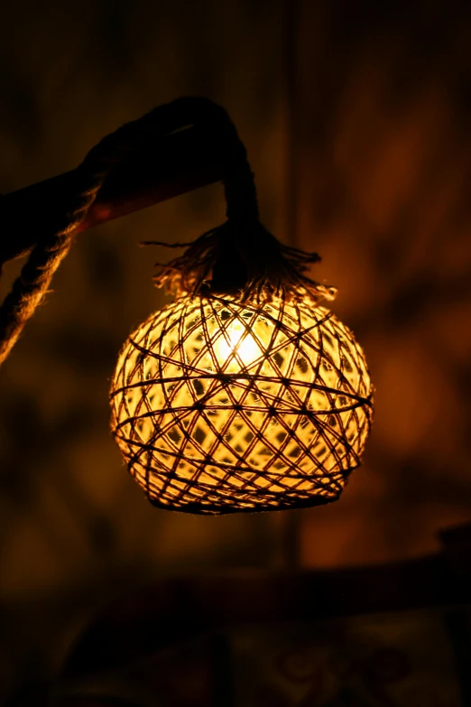 decorative hanging lantern in the dark lit by the light