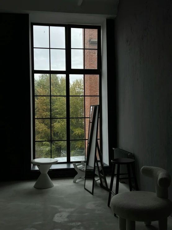a room with large windows and a ladder