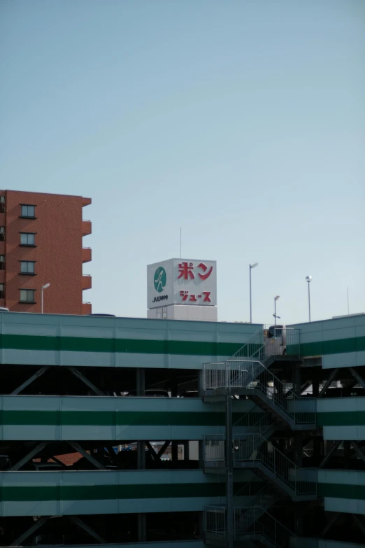 a large building with a green and white striped structure