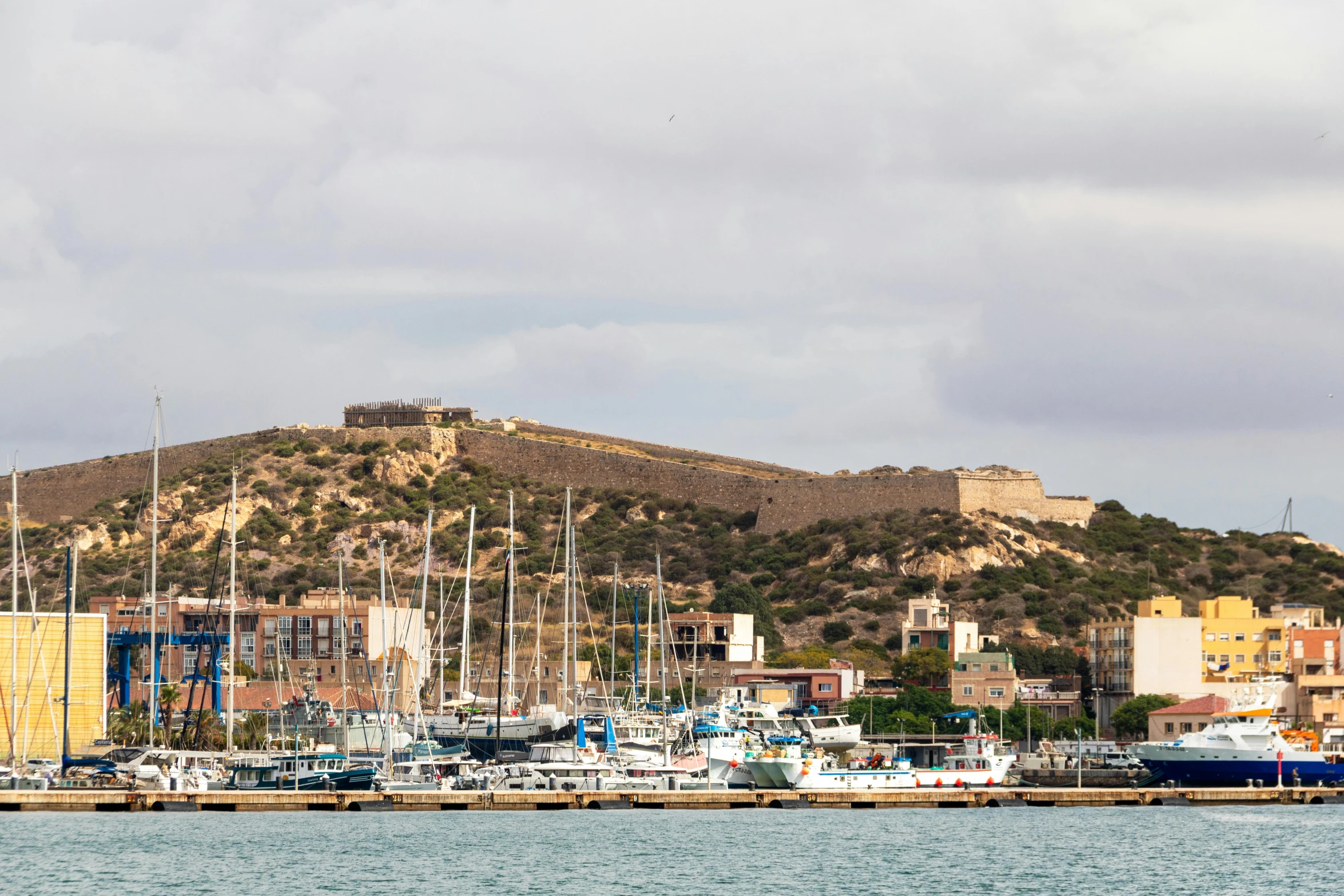 the city is surrounded by boats near the beach