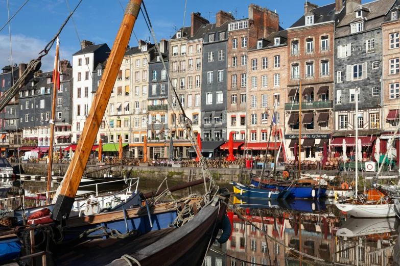 the boats are moored near some very tall buildings