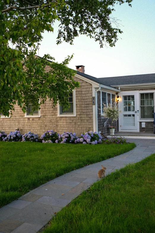 a home with a big lawn and flower beds