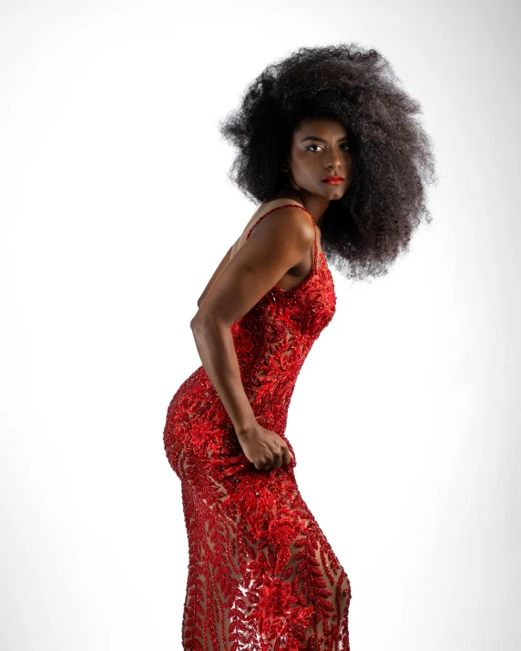 a woman in a red dress is standing in front of a white background