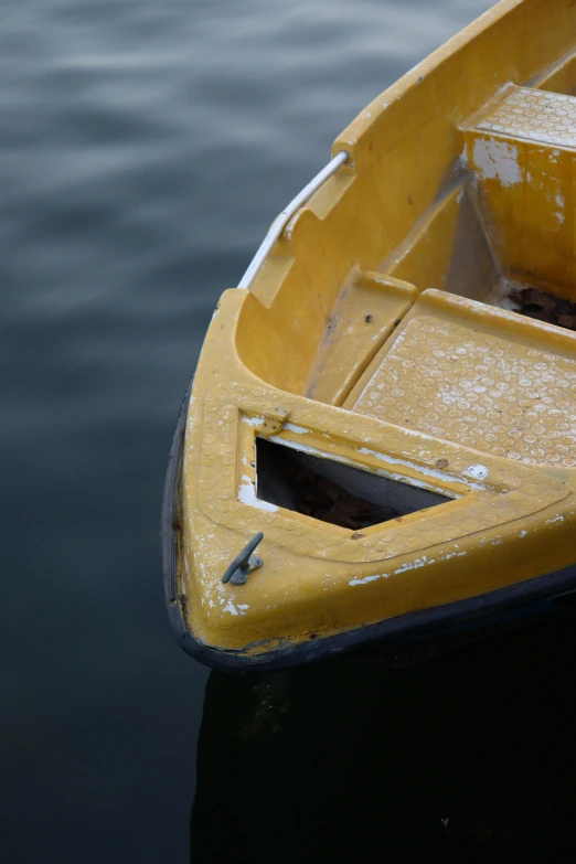 a wooden yellow canoe floating on water