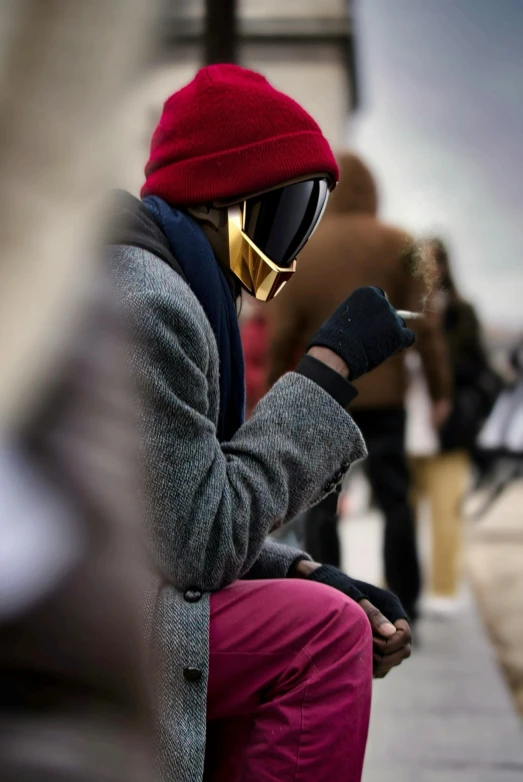 a man sitting down with his phone in his hand