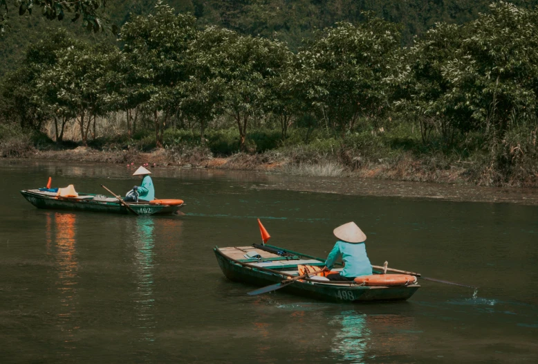 two people in small boats on the water