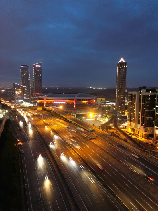 a very busy highway with some buildings and lights