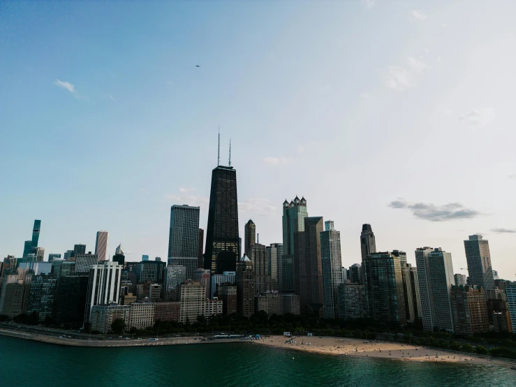 large buildings surrounded by water and city with blue sky