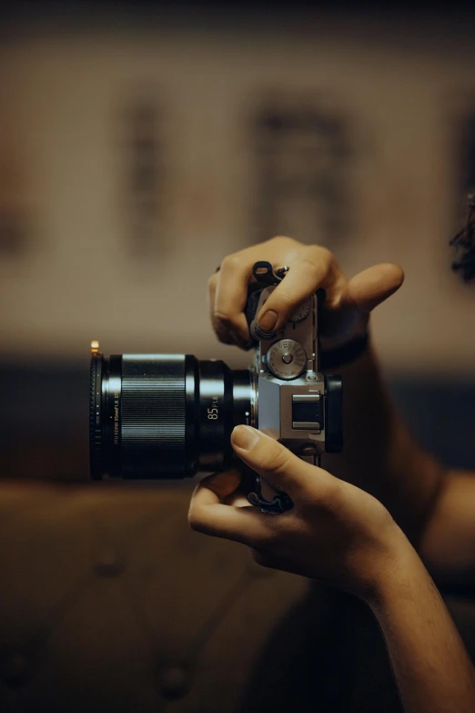 the young woman is holding a camera to take a picture