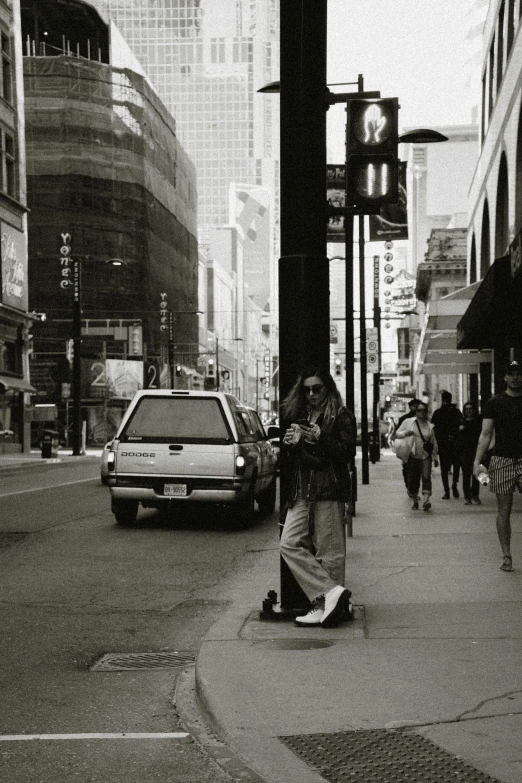 a man is holding on to a skateboard while people walk by