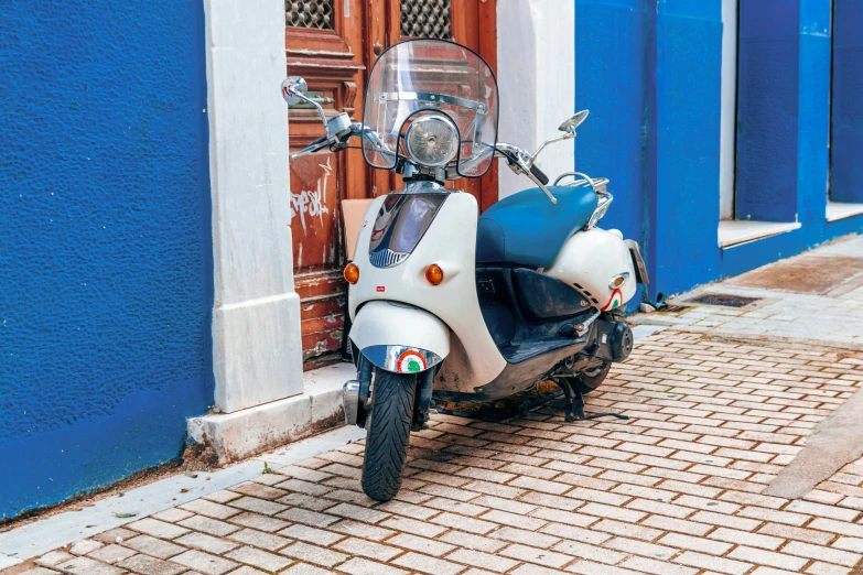 a moped parked on the side of the street