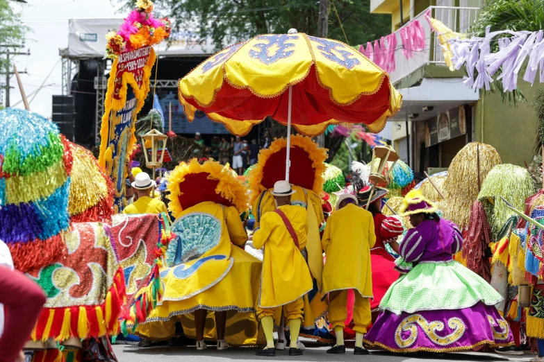 a group of people wearing yellow and red outfits