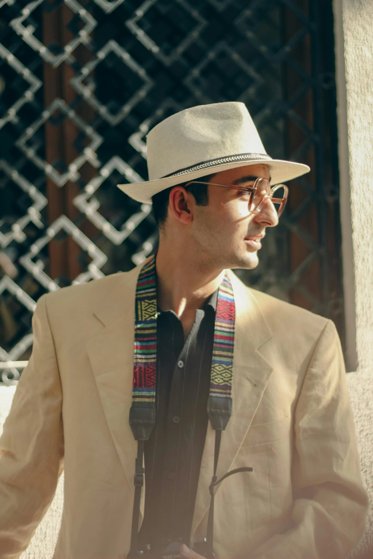 a man wearing a white hat, jacket and glasses