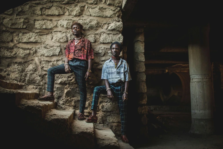 two people standing on steps next to each other