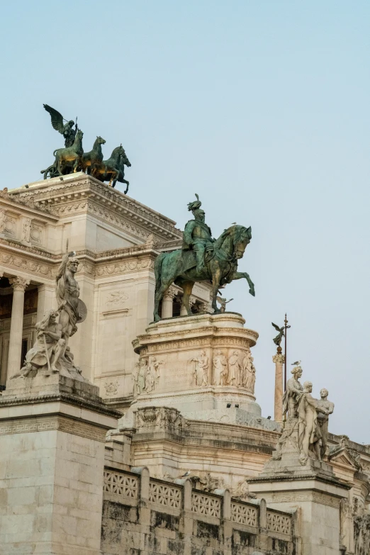 an ornate building has statues on top