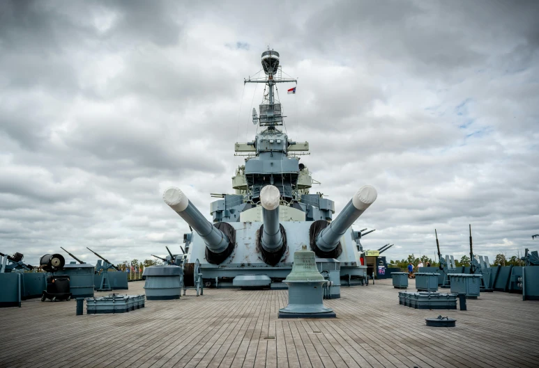 a large battleship sitting in a dock with chairs