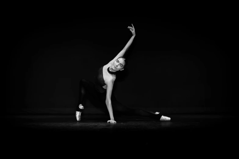 a young woman is doing a stretch on one leg