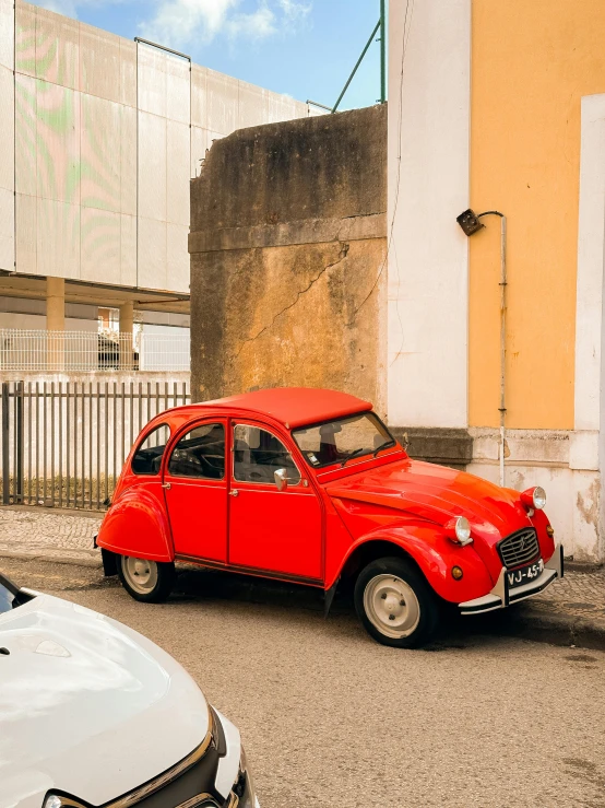 a red car is parked on the street