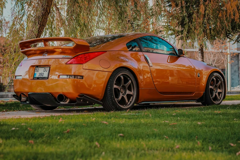 an orange sports car parked on the side of the road