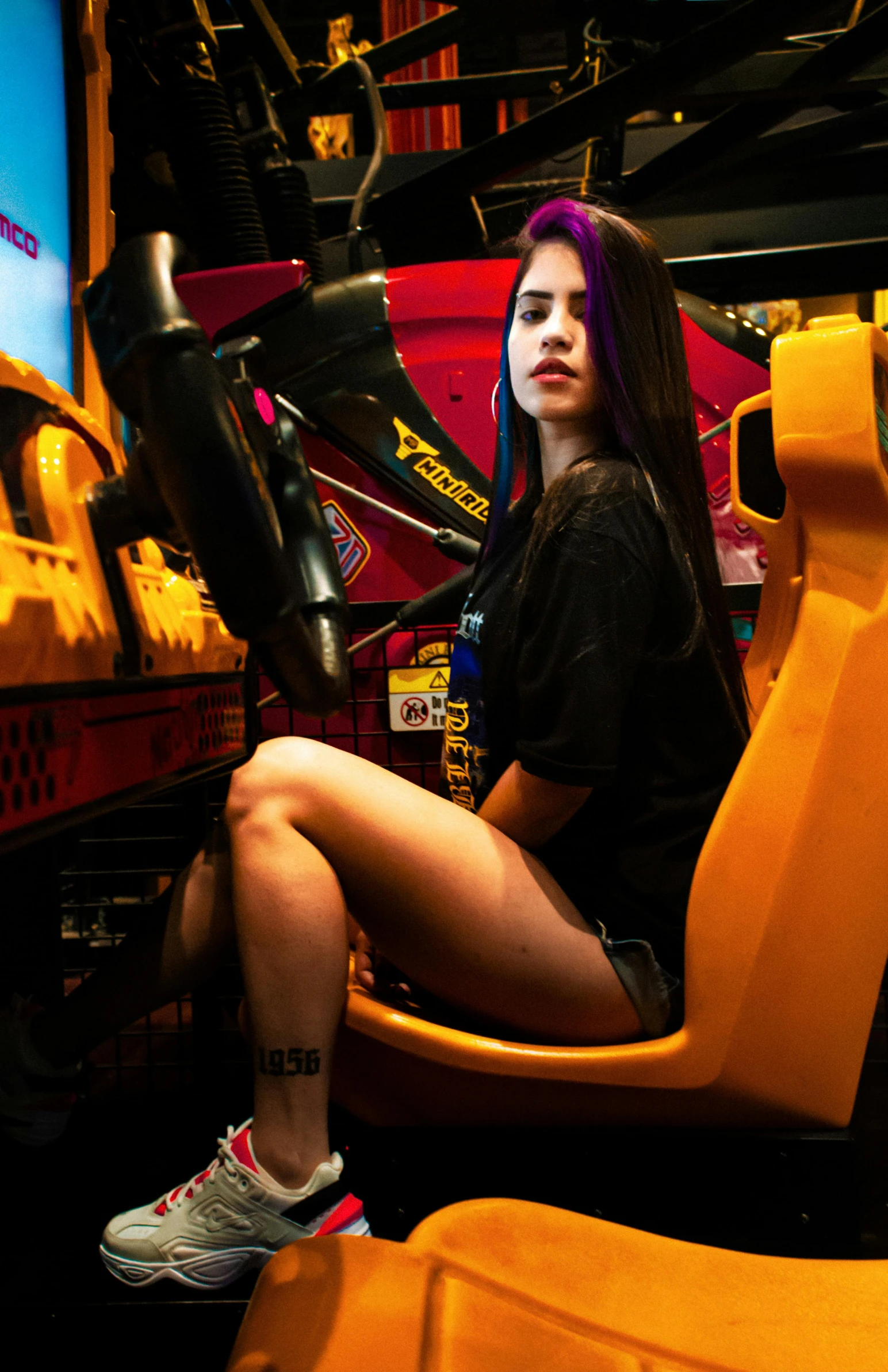 woman in black shirt sitting on yellow chair