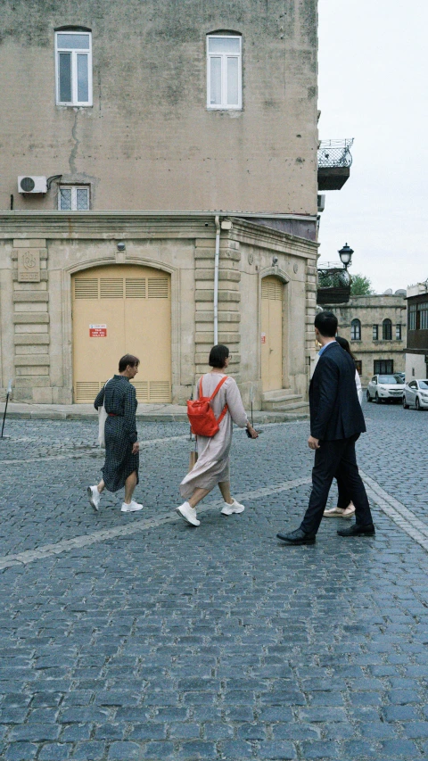 a group of people crossing a city street