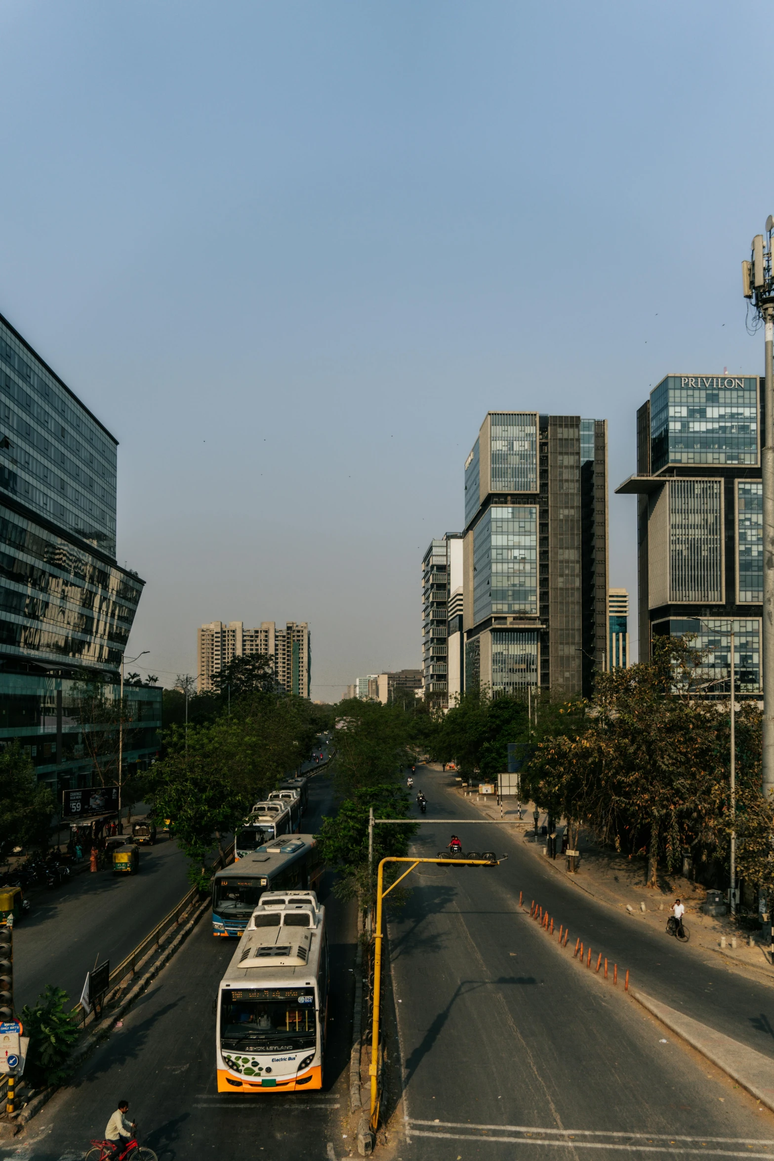 city buses are parked on a wide paved area