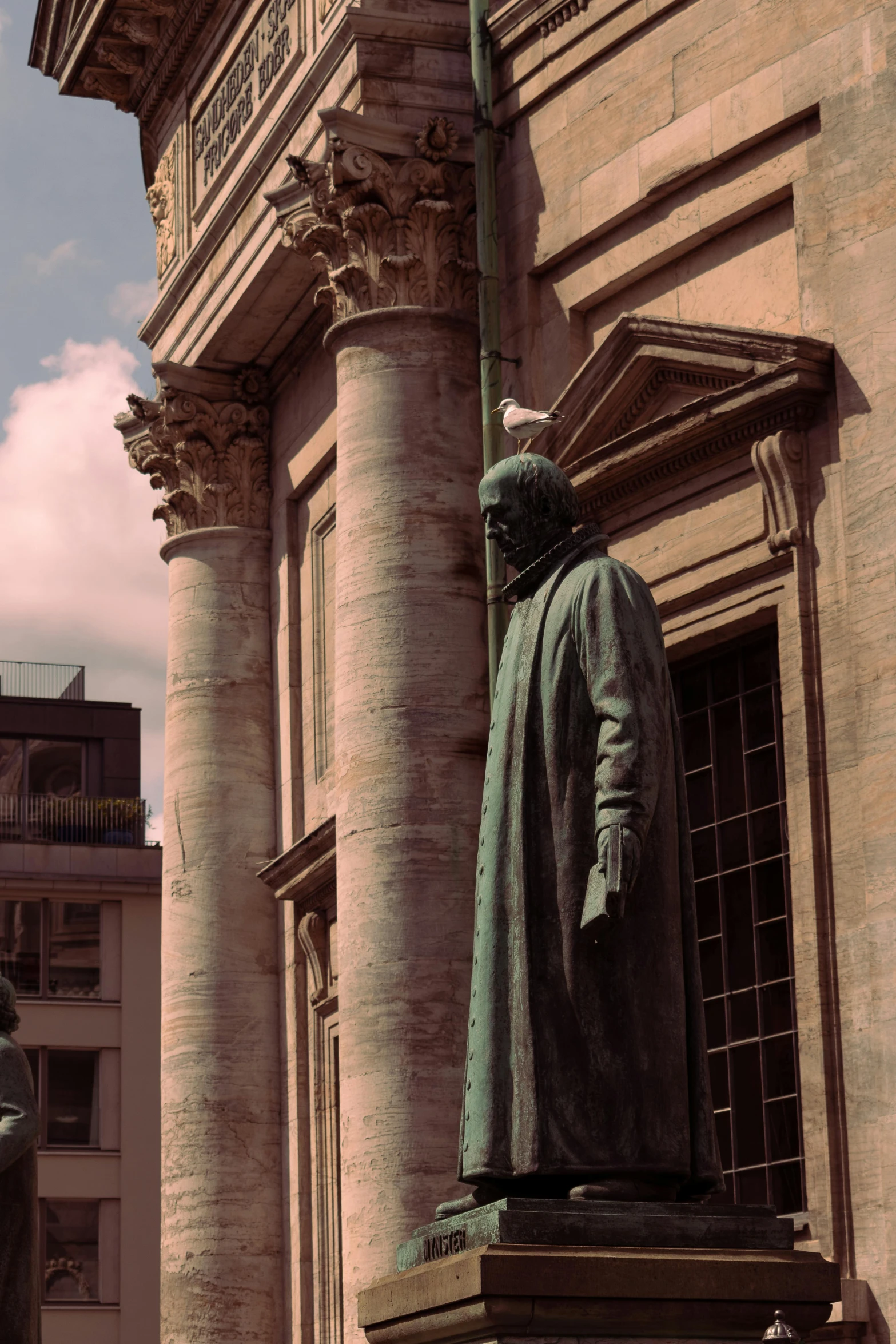 a statue is in front of a tall building