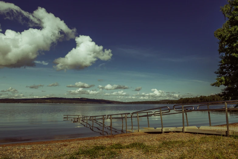 the lake has a long wooden pier with railing