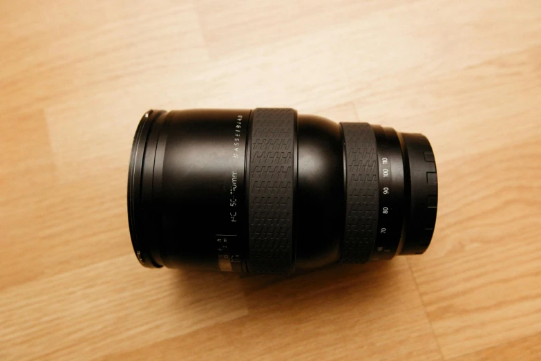 an overhead view of a camera lens sitting on a wood surface
