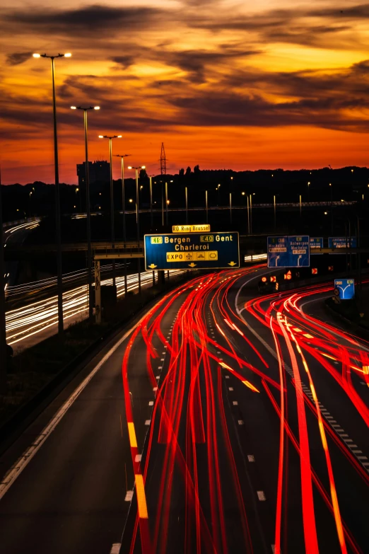 city traffic is light streaks against the dusk sky