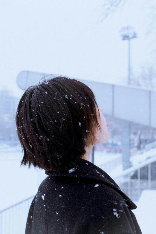 a woman staring into the distance with snow on the ground