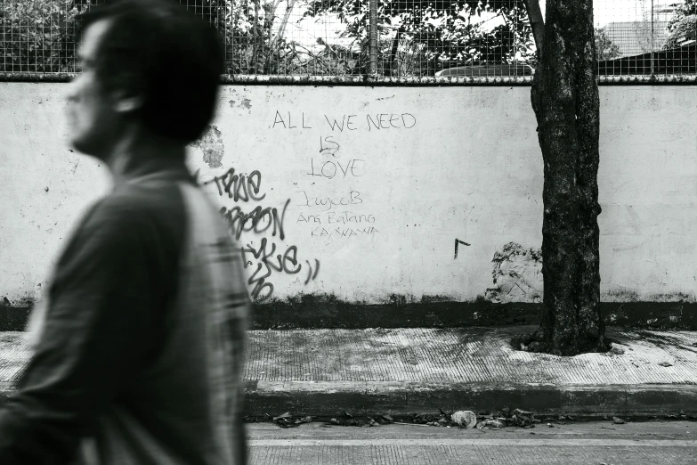 a person with a skateboard is walking by a wall