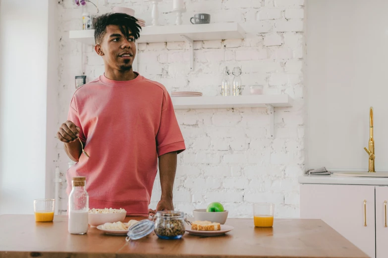 a person standing in front of a kitchen counter with food on it