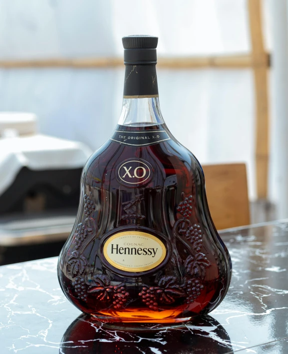 a bottle of hennessy on a table in the day light