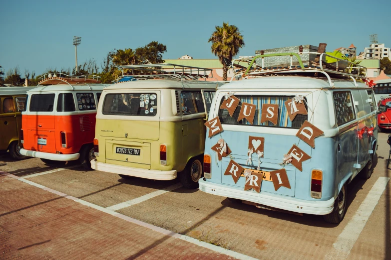 several old school bus parked in a lot