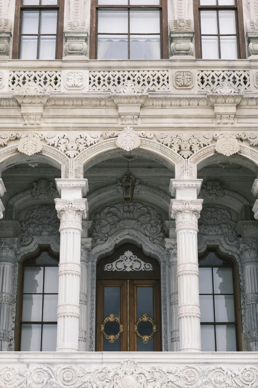 two doors with ornate carvings in front of a stone building