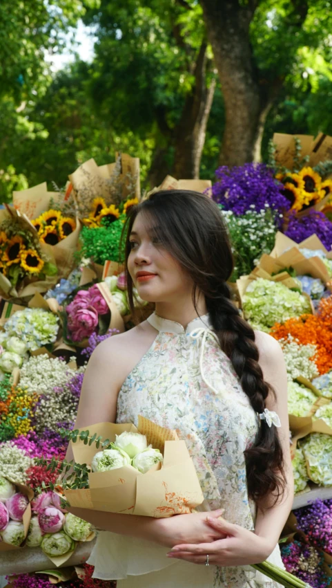 a girl is holding a bouquet of flowers