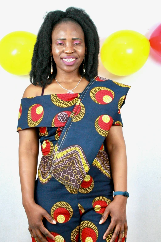 a woman posing with balloons behind her and a party balloon hanging in the background