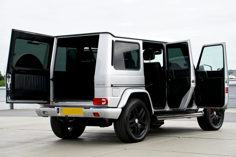 an suv with open doors sits parked in an airport