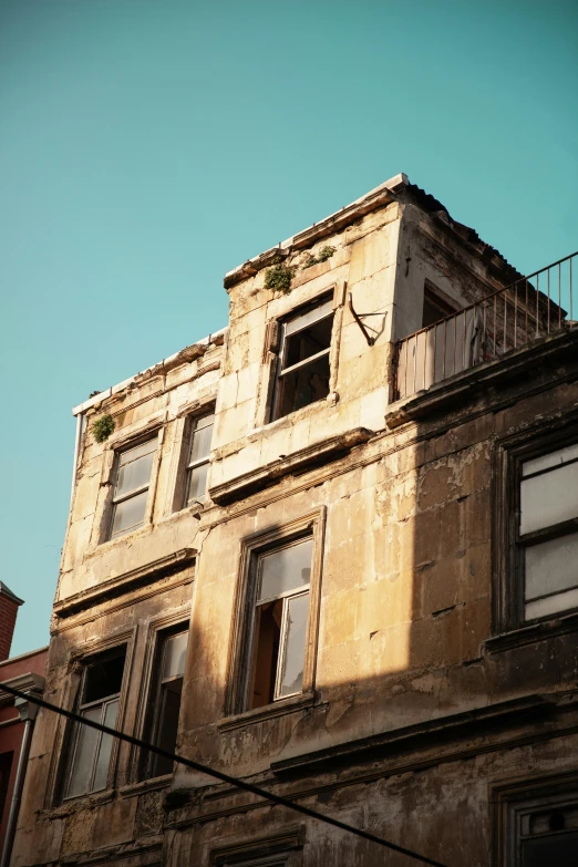 old building with balcony and a blue sky in the background