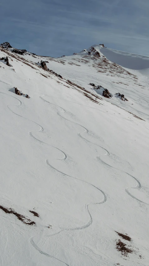 the ski is skiing down a mountain alone