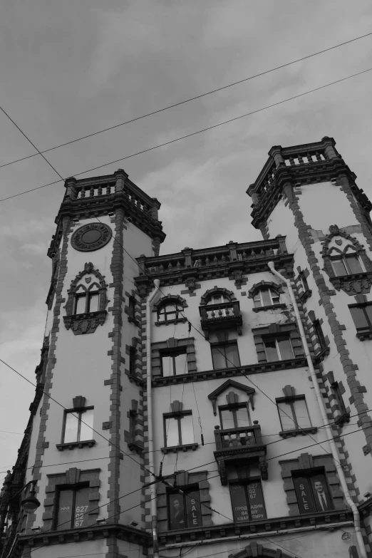 a tall building with windows and many balconies