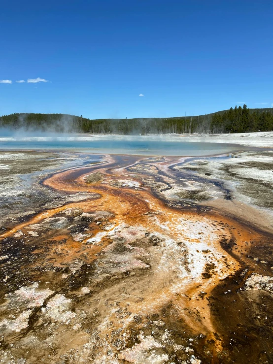 a view of a blue and green area with steam rising out of it