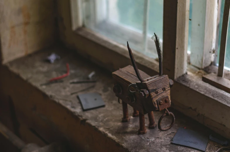 a toy horse and its basket on a window sill
