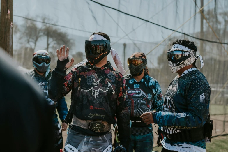 several people standing around while wearing dirt bikes gear