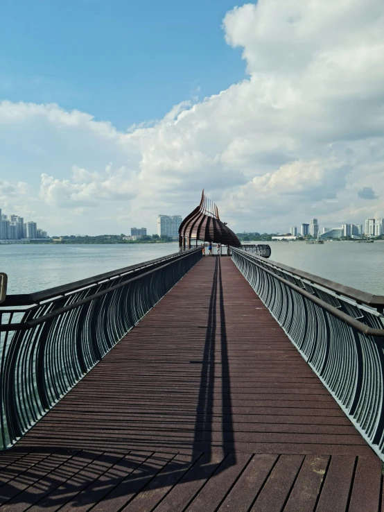 a pier in the middle of a harbor with a sky background